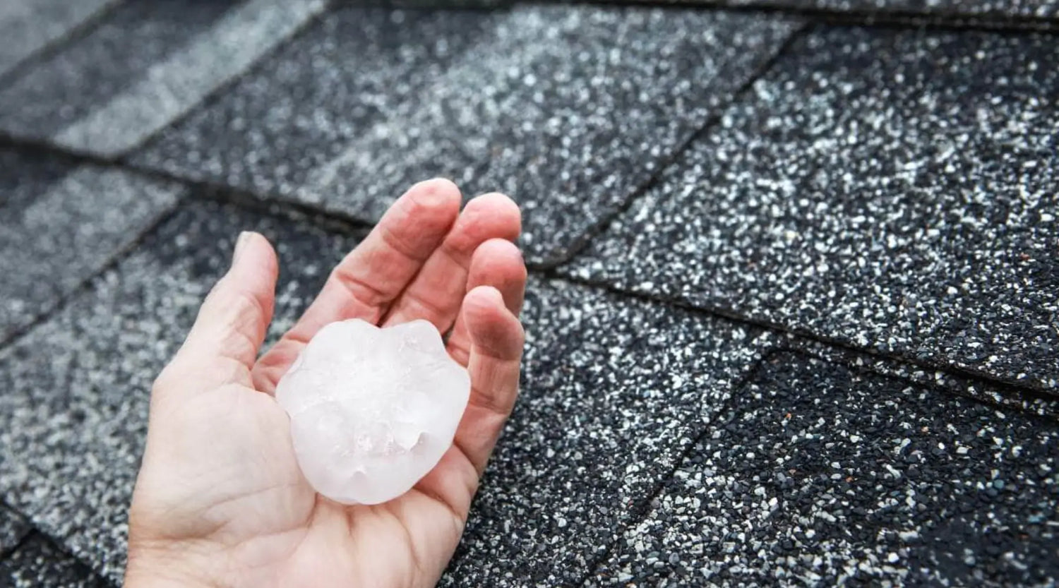 Large Hailstone Held In Hand Over Asphalt Shingle Roof, Showing Potential Storm Damage Risk – AllDone Construction