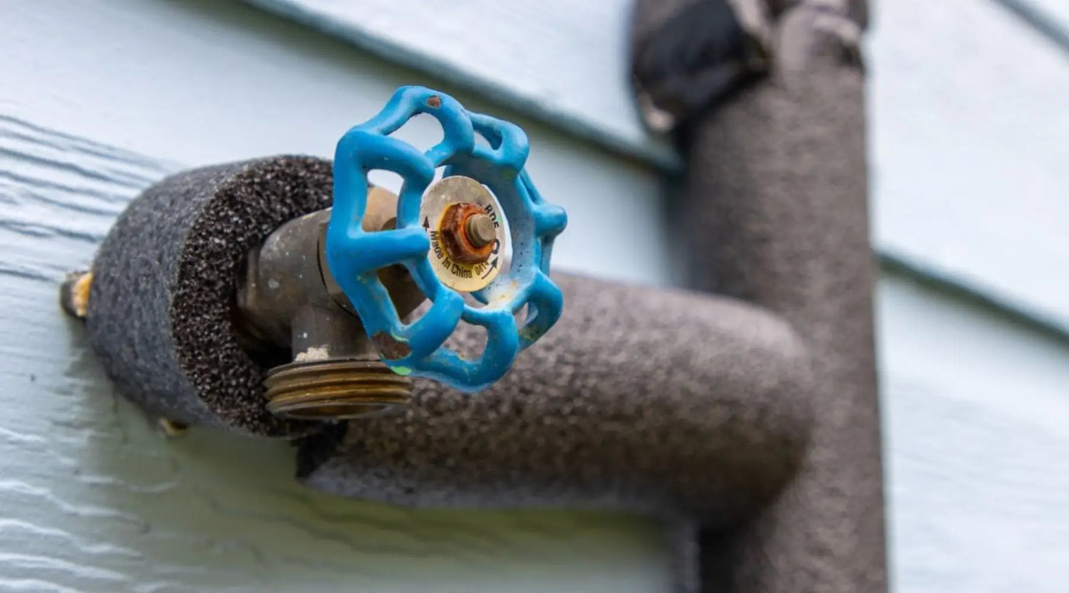 Outdoor faucet insulated with foam to prevent frozen pipes during winter in Austin and Hutto homes